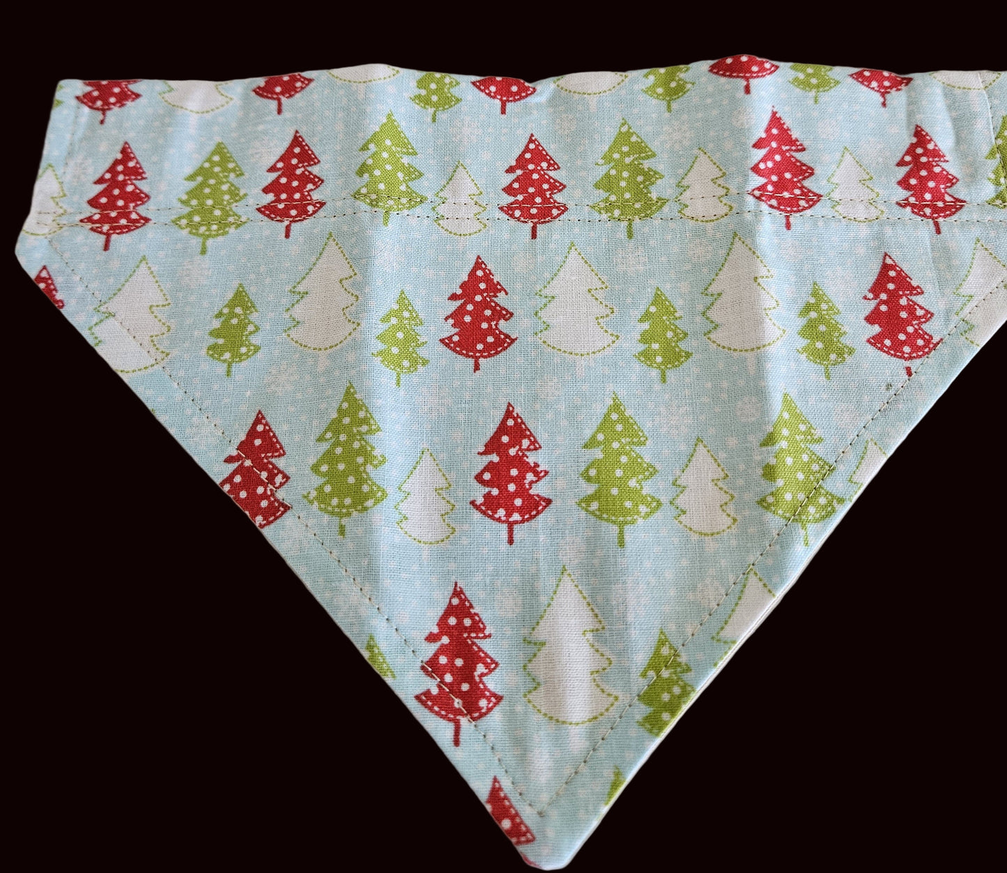 Fabric with Christmas tree pattern on a light blue background